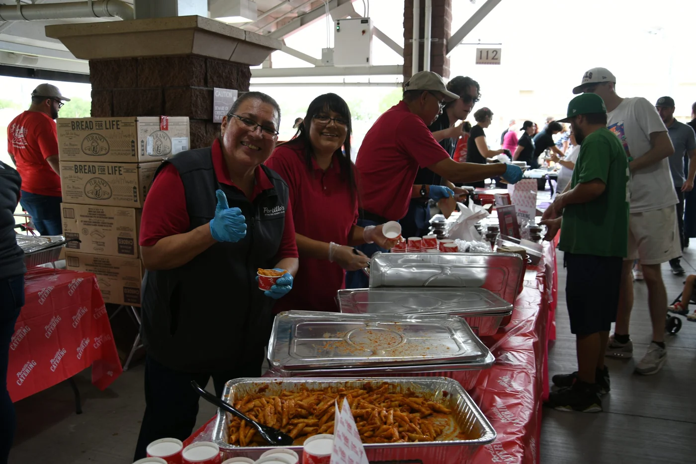 Restaurant teams sharing food samples at a past Taste of Surprise festival